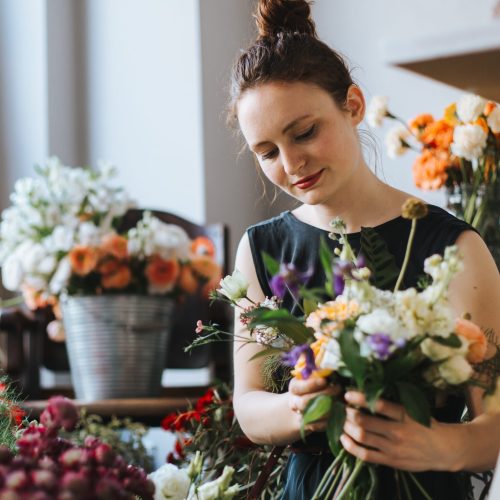 woman-arranging-flowers-shop
