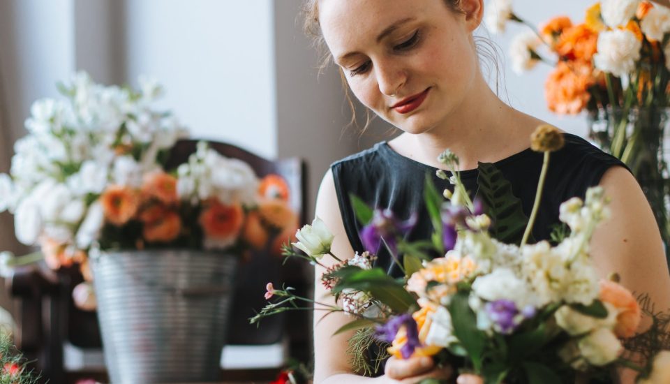 woman-arranging-flowers-shop